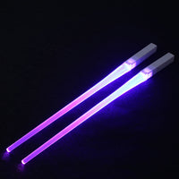 Pair of glowing chopsticks, featuring a sleek design with LED lights embedded in the handles, illuminating the entire length. Perfect for a fun, unique dining experience or themed events. Available in various colors, adding a vibrant touch to your sushi or asian meal.