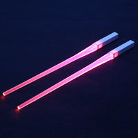 Pair of glowing chopsticks, featuring a sleek design with LED lights embedded in the handles, illuminating the entire length. Perfect for a fun, unique dining experience or themed events. Available in various colors, adding a vibrant touch to your sushi or asian meal.