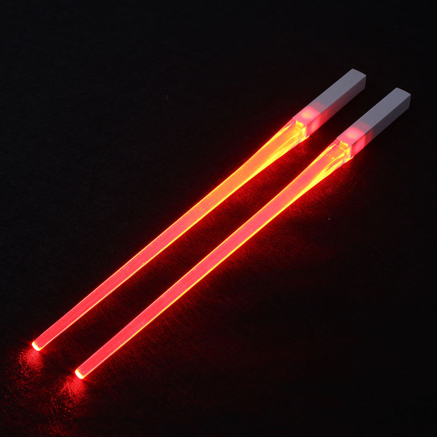 Pair of glowing chopsticks, featuring a sleek design with LED lights embedded in the handles, illuminating the entire length. Perfect for a fun, unique dining experience or themed events. Available in various colors, adding a vibrant touch to your sushi or asian meal.